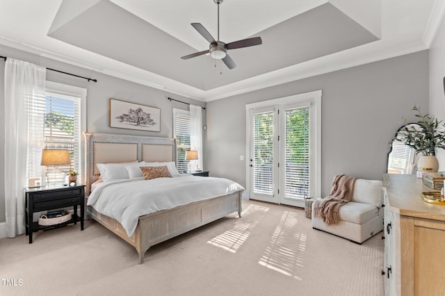 1412 Wakefield Farm Rd, Zebulon, NC 27597 - bedroom featuring a tray ceiling, access to exterior, light carpet, a ceiling fan, and ornamental molding