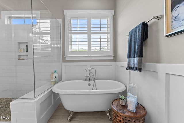 1412 Wakefield Farm Rd, Zebulon, NC 27597 - bathroom featuring a freestanding tub, tiled shower, healthy amount of natural light, and a wainscoted wall