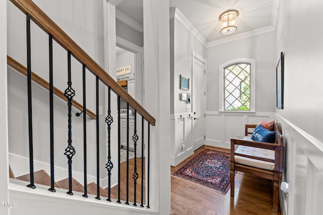 1412 Wakefield Farm Rd, Zebulon, NC 27597 - entrance foyer featuring ornamental molding, wood finished floors, a decorative wall, wainscoting, and stairway