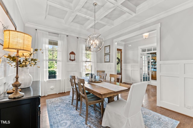 1412 Wakefield Farm Rd, Zebulon, NC 27597 - dining room with wood finished floors, a chandelier, beamed ceiling, wainscoting, and coffered ceiling