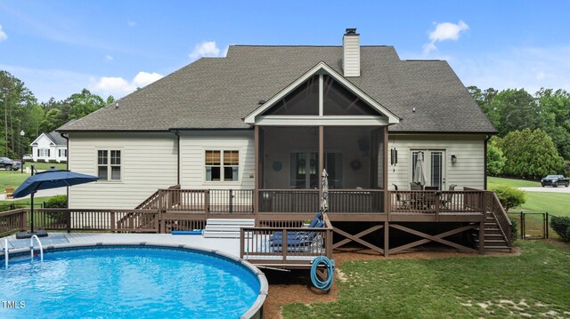 1412 Wakefield Farm Rd, Zebulon, NC 27597 - back of property featuring a wooden deck, a sunroom, a chimney, and a yard