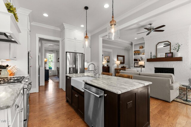 1412 Wakefield Farm Rd, Zebulon, NC 27597 - kitchen with stainless steel appliances, custom exhaust hood, a sink, ceiling fan, and white cabinets