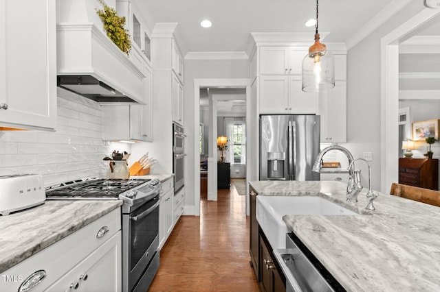 1412 Wakefield Farm Rd, Zebulon, NC 27597 - kitchen with stainless steel appliances, custom exhaust hood, white cabinetry, pendant lighting, and recessed lighting