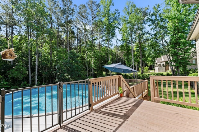 1412 Wakefield Farm Rd, Zebulon, NC 27597 - outdoor pool featuring a wooden deck and view of wooded area