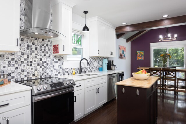 2805 Fayetteville St, Durham, NC 27707 - kitchen with appliances with stainless steel finishes, wall chimney range hood, a sink, butcher block countertops, and decorative light fixtures