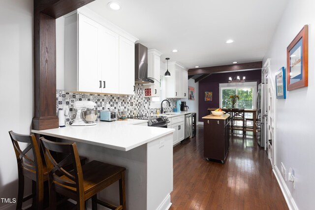 2805 Fayetteville St, Durham, NC 27707 - kitchen featuring wall chimney exhaust hood, a sink, stainless steel appliances, light countertops, and tasteful backsplash