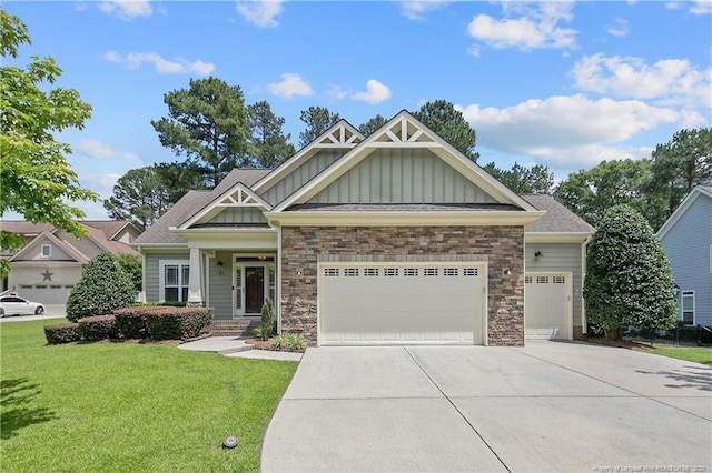 71 Orchard Falls Dr, Spring Lake, NC 28390 - craftsman-style home featuring board and batten siding, a garage, driveway, a front lawn, and stone siding
