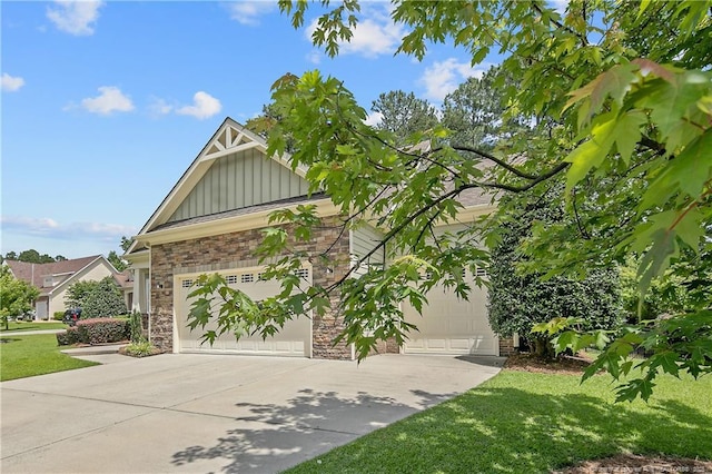 71 Orchard Falls Dr, Spring Lake, NC 28390 - view of front of property featuring board and batten siding, stone siding, concrete driveway, a front lawn, and a garage