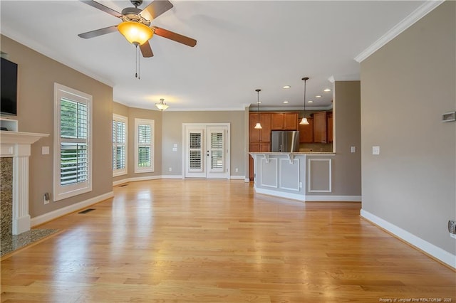 71 Orchard Falls Dr, Spring Lake, NC 28390 - unfurnished living room featuring crown molding, baseboards, a ceiling fan, light wood finished floors, and a fireplace