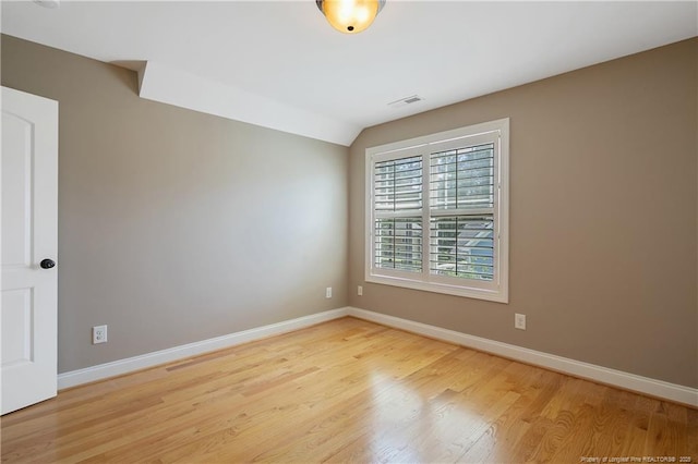 71 Orchard Falls Dr, Spring Lake, NC 28390 - spare room with baseboards, wood finished floors, and vaulted ceiling