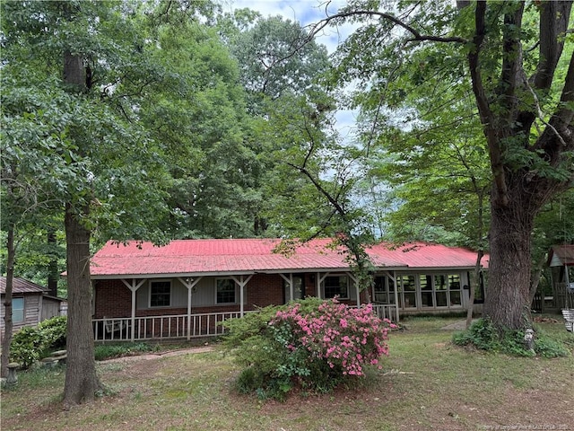 467 Deep River Rd, Sanford, NC 27330 - view of front of home with covered porch, metal roof, and brick siding