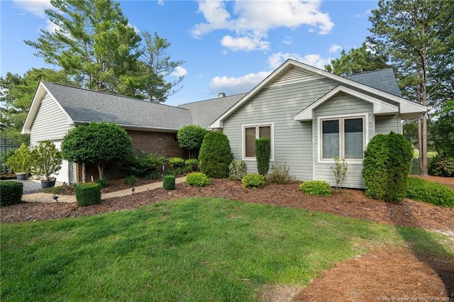 116 Fox Run Ct, West End, NC 27376 - single story home featuring a front lawn, a shingled roof, a garage, and brick siding