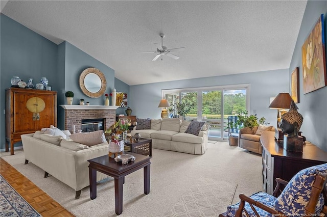 116 Fox Run Ct, West End, NC 27376 - living area featuring vaulted ceiling, a ceiling fan, a textured ceiling, and a fireplace
