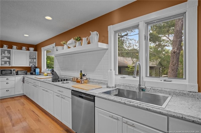 116 Fox Run Ct, West End, NC 27376 - kitchen with appliances with stainless steel finishes, open shelves, a sink, white cabinetry, and a textured ceiling