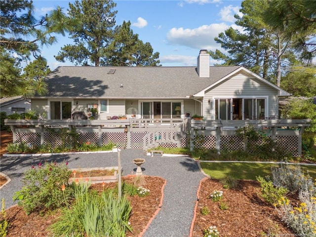 116 Fox Run Ct, West End, NC 27376 - view of front of property featuring a wooden deck, a chimney, and roof with shingles