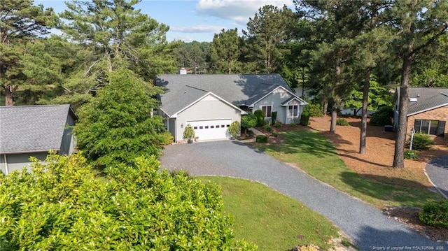 116 Fox Run Ct, West End, NC 27376 - view of front of house with driveway, an attached garage, and a front lawn