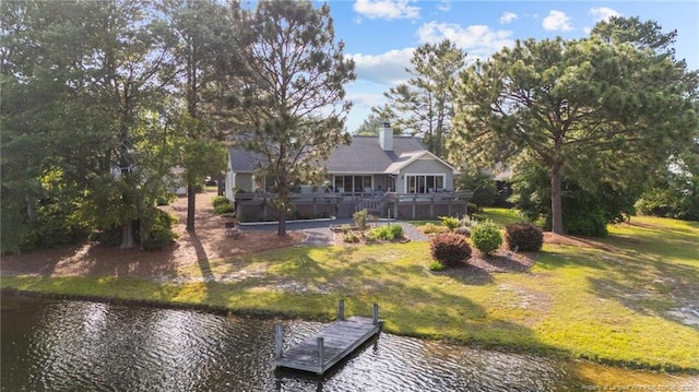 116 Fox Run Ct, West End, NC 27376 - rear view of house with a water view, a lawn, and a chimney