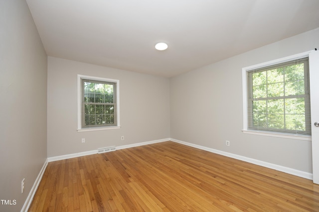 1209 Landon St, Durham, NC 27703 - empty room with light wood-style floors and baseboards