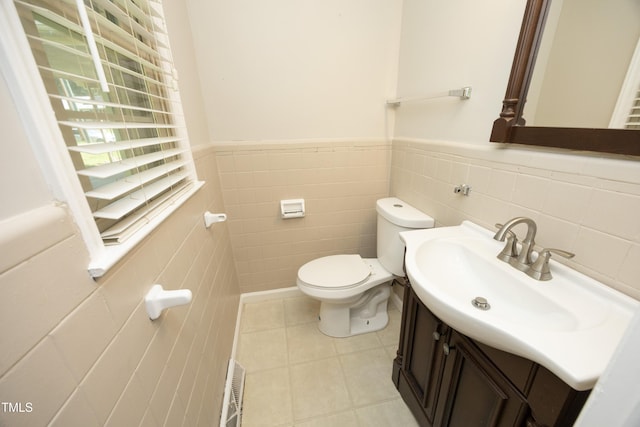 1209 Landon St, Durham, NC 27703 - half bathroom with tile walls, toilet, vanity, tile patterned flooring, and a wainscoted wall