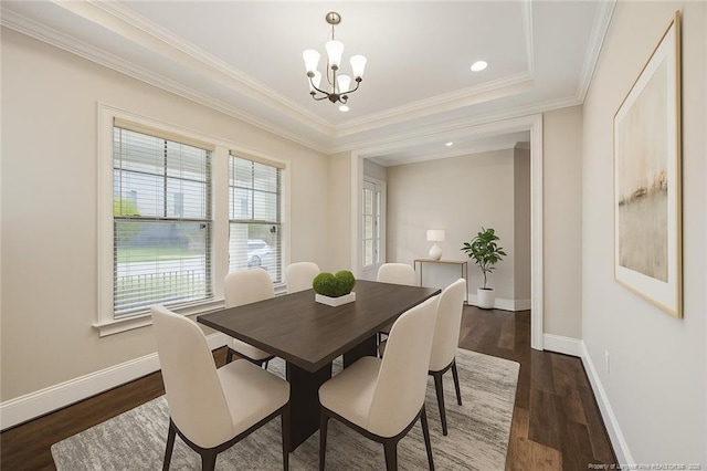 405 Gilpin Way, Cary, NC 27519 - dining area with a chandelier, dark wood-style flooring, crown molding, and a tray ceiling