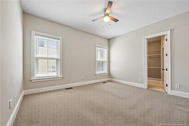 405 Gilpin Way, Cary, NC 27519 - unfurnished bedroom with carpet flooring, multiple windows, and ceiling fan