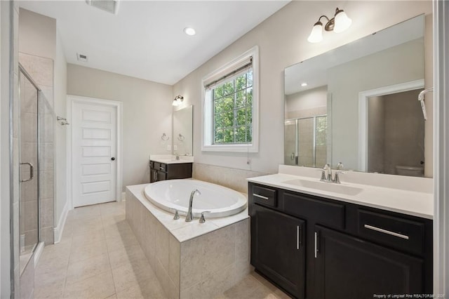 405 Gilpin Way, Cary, NC 27519 - bathroom with a stall shower, two vanities, a bath, tile patterned floors, and recessed lighting