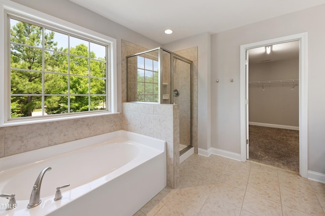 1600 Drift Falls Ln, Wendell, NC 27591 - full bathroom featuring a bath, a shower stall, plenty of natural light, a spacious closet, and recessed lighting