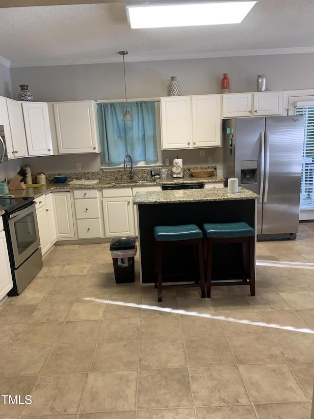 352 Riverstone Dr, Clayton, NC 27527 - kitchen with appliances with stainless steel finishes, a sink, light stone counters, white cabinets, and crown molding