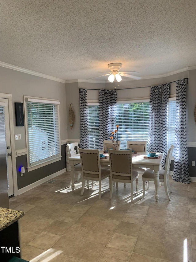 352 Riverstone Dr, Clayton, NC 27527 - dining room featuring a textured ceiling, a ceiling fan, crown molding, and baseboards