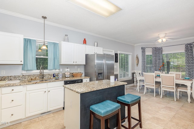 352 Riverstone Dr, Clayton, NC 27527 - kitchen featuring stainless steel fridge with ice dispenser, a breakfast bar, ornamental molding, white cabinetry, and a kitchen island