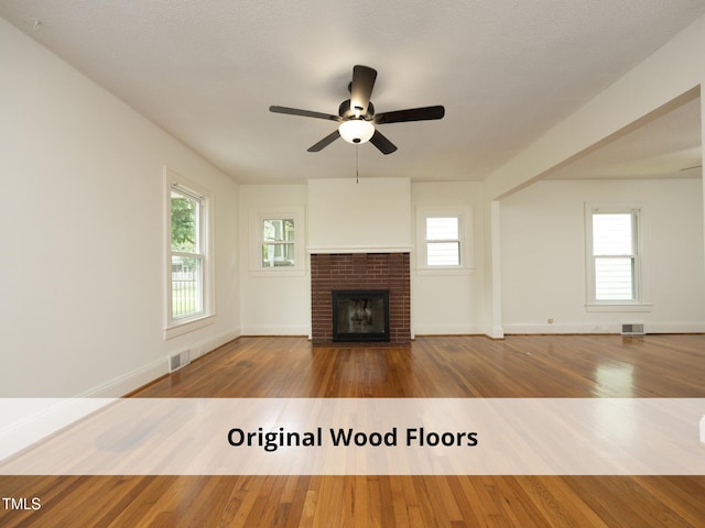 1410 Shawnee St, Durham, NC 27701 - unfurnished living room featuring a ceiling fan, wood finished floors, and a brick fireplace
