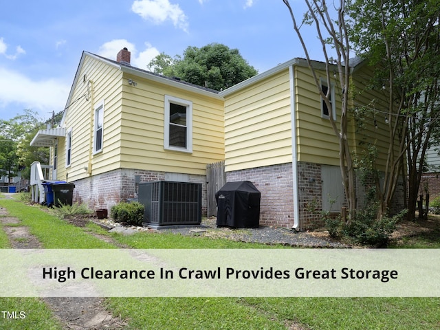 1410 Shawnee St, Durham, NC 27701 - view of side of property featuring a chimney and brick siding