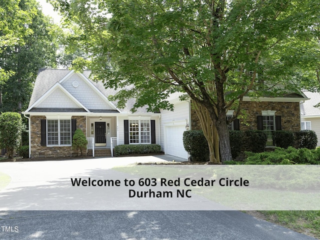 603 Red Cedar Cir, Durham, NC 27712 - view of front of property with stone siding, concrete driveway, and an attached garage
