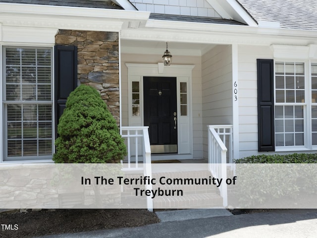 603 Red Cedar Cir, Durham, NC 27712 - view of exterior entry featuring stone siding and roof with shingles