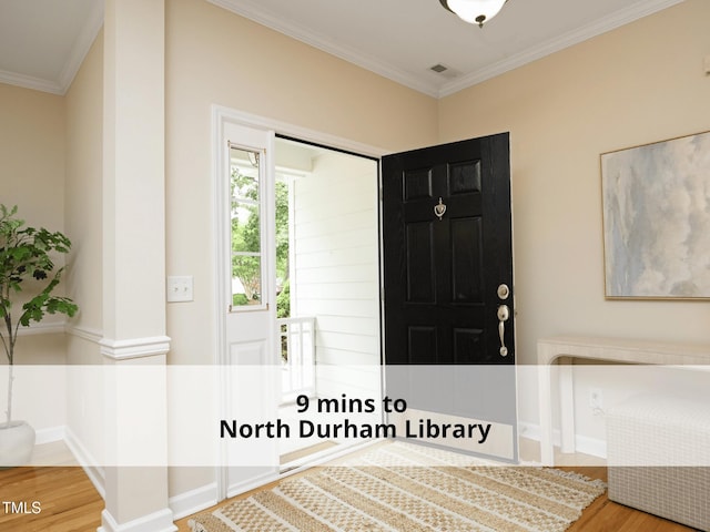 603 Red Cedar Cir, Durham, NC 27712 - entrance foyer featuring wood finished floors and crown molding