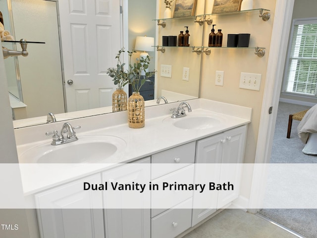 603 Red Cedar Cir, Durham, NC 27712 - ensuite bathroom featuring double vanity and baseboards