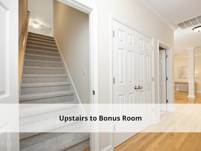 603 Red Cedar Cir, Durham, NC 27712 - stairway with crown molding and wood finished floors