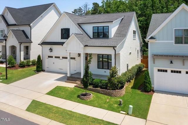 245 Tumbling River Dr, Wendell, NC 27591 - view of front of home with board and batten siding, concrete driveway, a shingled roof, and a front yard