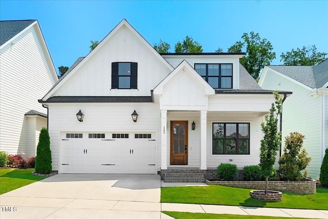 245 Tumbling River Dr, Wendell, NC 27591 - modern inspired farmhouse featuring board and batten siding, a front lawn, concrete driveway, and covered porch