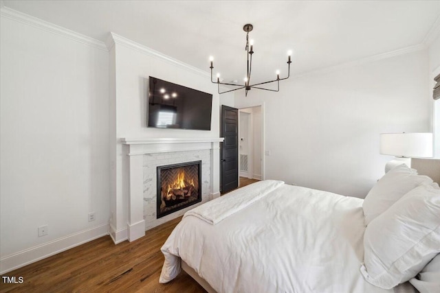 245 Tumbling River Dr, Wendell, NC 27591 - bedroom with a chandelier, wood finished floors, ornamental molding, baseboards, and a lit fireplace