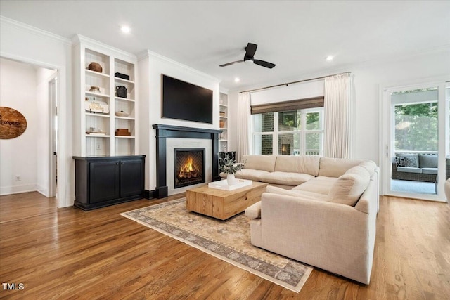 245 Tumbling River Dr, Wendell, NC 27591 - living room featuring wood finished floors, a ceiling fan, crown molding, recessed lighting, and built in shelves