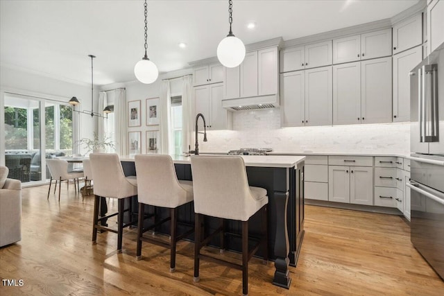 245 Tumbling River Dr, Wendell, NC 27591 - kitchen with decorative backsplash, high quality fridge, a kitchen island with sink, light countertops, and pendant lighting