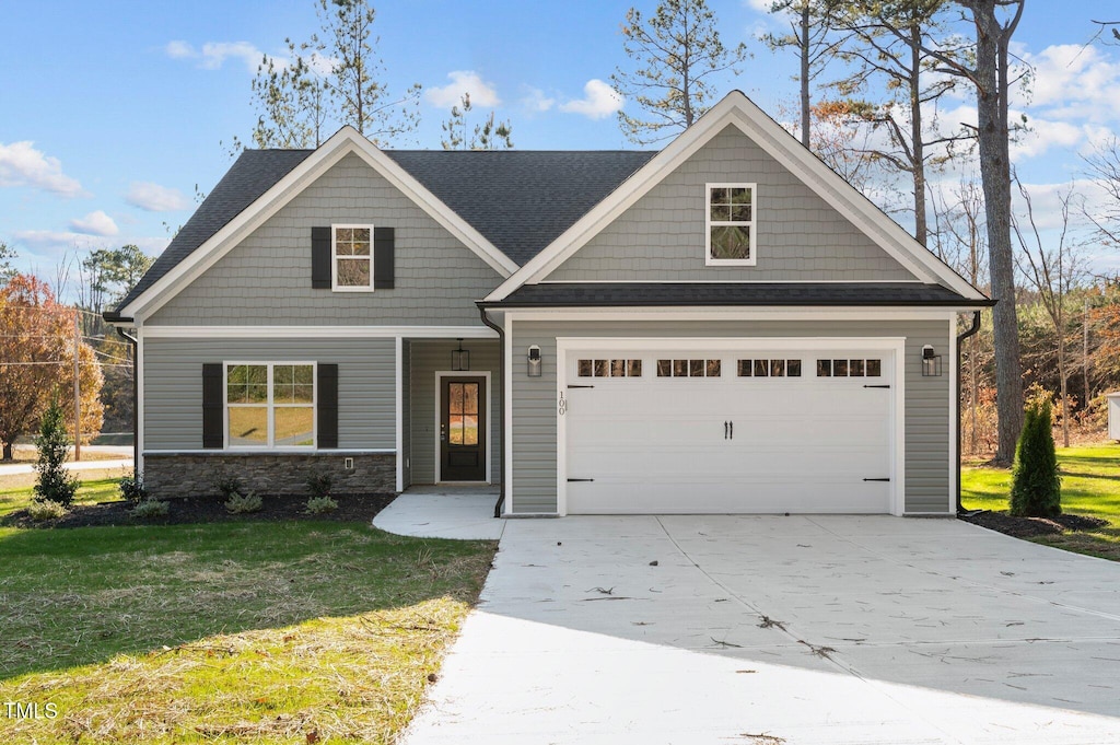 100 Carol Cir Unit 17, Louisburg, NC 27549 - craftsman-style house with concrete driveway, a front yard, a garage, and stone siding
