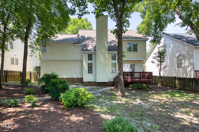 203 Halls Mill Dr, Cary, NC 27519 - back of house featuring a fenced backyard, a wooden deck, a chimney, and roof with shingles