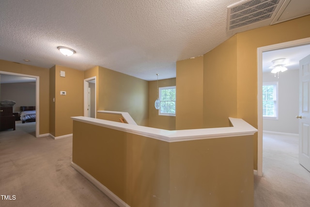 203 Halls Mill Dr, Cary, NC 27519 - hall with an upstairs landing, light carpet, a textured ceiling, and baseboards