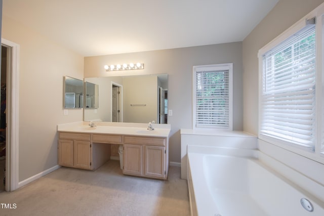 203 Halls Mill Dr, Cary, NC 27519 - bathroom with double vanity, a bath, and baseboards