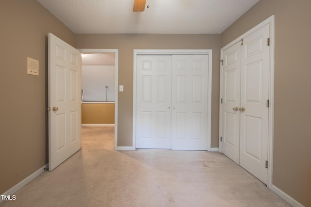203 Halls Mill Dr, Cary, NC 27519 - unfurnished bedroom with light carpet, baseboards, a closet, ceiling fan, and a textured ceiling