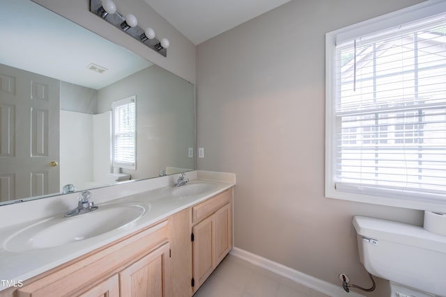 203 Halls Mill Dr, Cary, NC 27519 - full bath with toilet, double vanity, baseboards, tile patterned flooring, and a shower