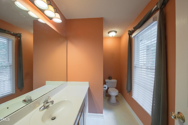 203 Halls Mill Dr, Cary, NC 27519 - bathroom with toilet, vanity, and baseboards