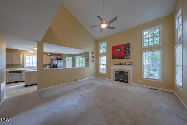 203 Halls Mill Dr, Cary, NC 27519 - unfurnished living room featuring high vaulted ceiling, a glass covered fireplace, light carpet, a ceiling fan, and baseboards
